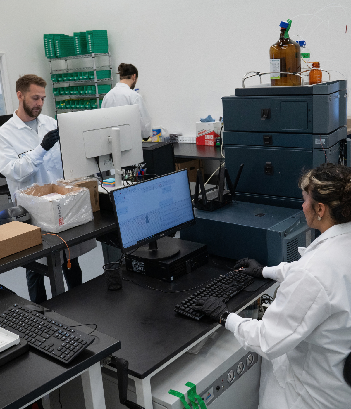 Optiq Health Labs scientists working with analytical laboratory equipment for peptide testing.